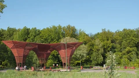 Spring park with visitors resting in stylish wooden arbors Stock-Footage 133199874