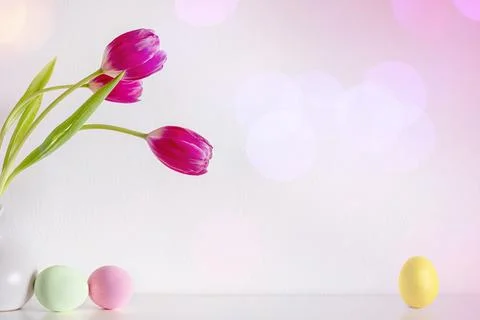 Spring pink tulip flowers with Easter eggs on pink background Stock Photos