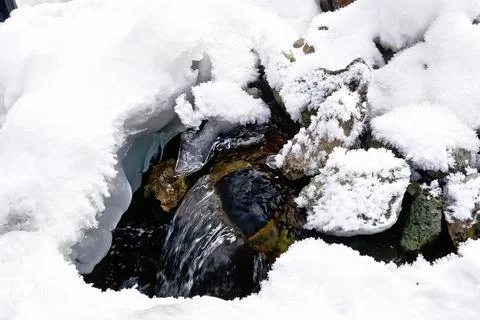 Spring from pipe in winter Stock Photos