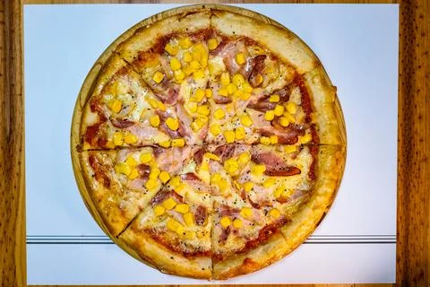 Spring pizza, ham, corn, and bacon Stock Photos