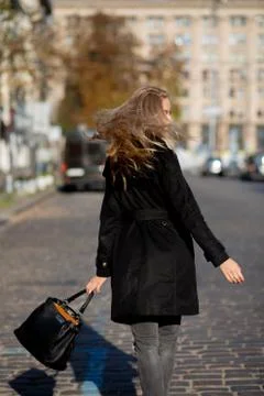 Spring portrait of cool young woman enjoying warm weather, wearing coat and j Stock Photos
