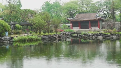 Spring Rain Falls Over a Classic Garden Lake Surface with Gentle Ripples Stock Footage 341918104