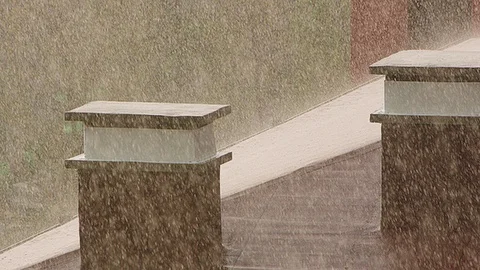 Spring rain on a rooftop with chimneys at sunset slow motion Stock Footage 88704860