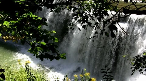 Spring rain runoff over falls, zoom out and pan left  JPEG A 70% Stock Footage 2920979