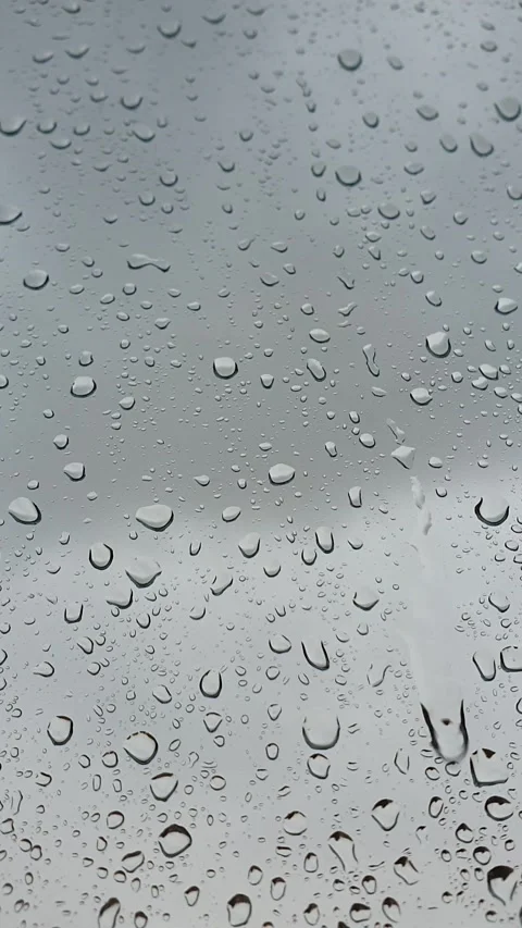 Spring rain on window against grey sky Stock Footage 156237690