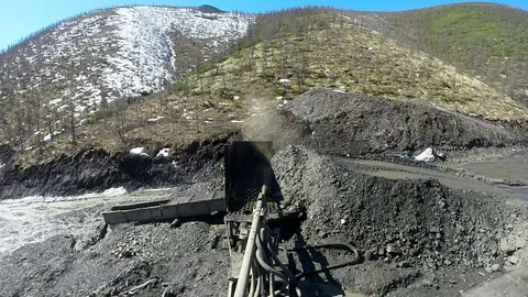 Spring. Real Gold mining on an old vintage washing device. Susuman. Kolyma Stock Footage 119792636
