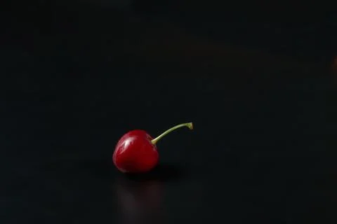 Spring red cherries on black background selective focus cherry Stock Photos
