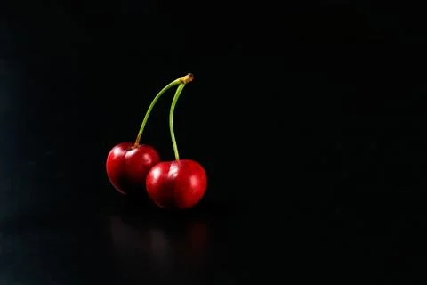 Spring red cherries on black background selective focus cherry Stock Photos