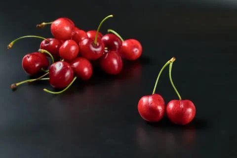 Spring red cherries on black background selective focus cherry Stock Photos