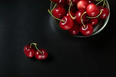 Spring red cherries on black background selective focus cherry Stock Photos