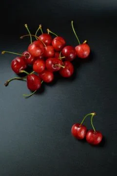 Spring red cherries on black background selective focus cherry Stock Photos