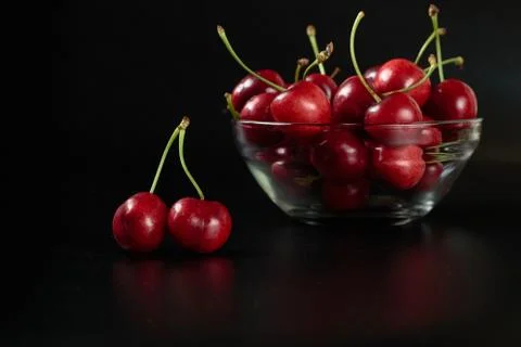 Spring red cherries on black background selective focus cherry Stock Photos