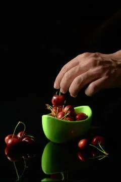 Spring red cherries on black background selective focus cherry Stock Photos