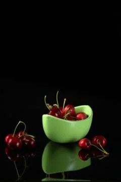 Spring red cherries on black background selective focus cherry Stock Photos