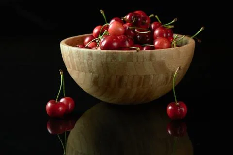 Spring red cherries on black background selective focus cherry Stock Photos