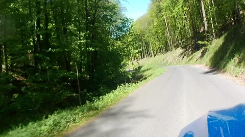 Spring ride through forest on local mountain road in Stiavnica mountains Stock Footage 334510270