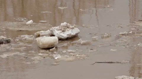 Spring river with dirty brown water and ice. floating of ice Video stock 65286094