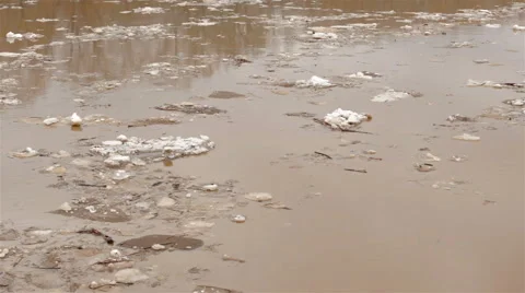Spring river with dirty brown water and ice. floating of ice Video stock 65286145