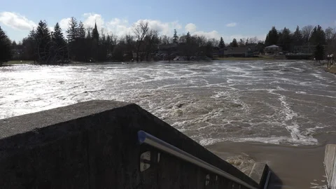 Spring river flooding during record warm temperatures in Ontario Canada Stock Footage 150294775