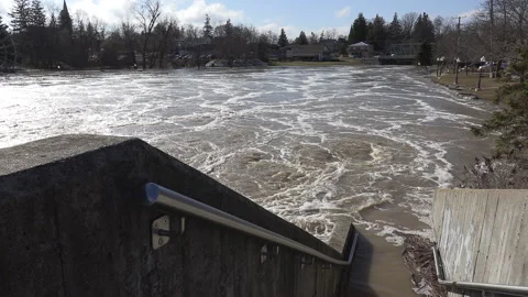 Spring river flooding during record warm temperatures in Ontario Canada Stock Footage 150296469