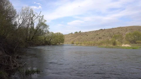 Spring river with hilly riverside, 4K 2160p video clip Stock Footage 86008512