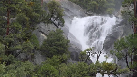 A Spring river waashes over rocks in Yosemite valley Stock Footage 62631654