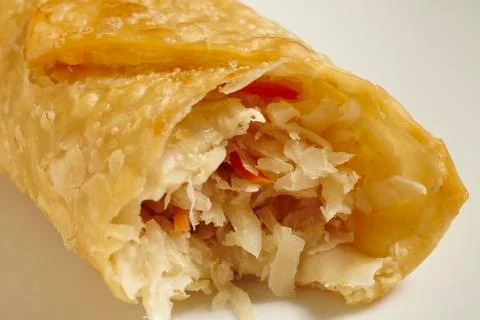 A spring roll with a bite taken out (China) Stock Photos