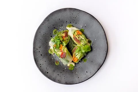 Spring roll on a black plate isolated Stock Photos