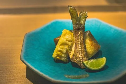 Spring roll filled with tender fish and crispy baby corn tempura, elegantly.. Stock Photos