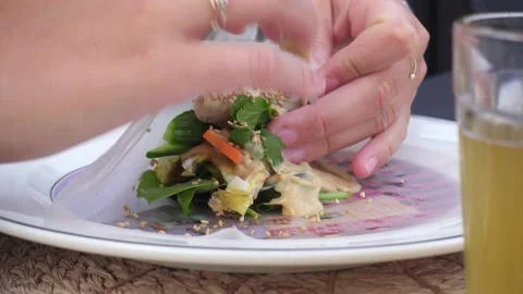 Spring roll folding healthy food dirty hands sauce peanut butter beer glass Stock Footage