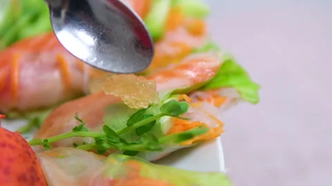 Spring rolls decorated with pike caviar. River fish caviar. Golden caviar Stock Footage 302089984