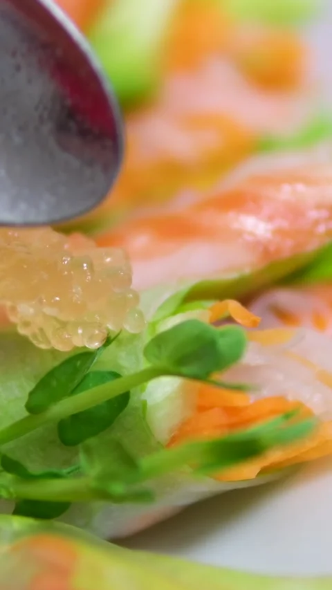 Spring rolls decorated with pike caviar. River fish caviar. Golden caviar Stock Footage 302735904