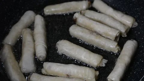 Spring rolls in deep oil Stock Footage 144492879