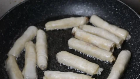 Spring rolls in deep oil Stock Footage 144494158
