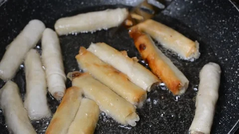Spring rolls in deep oil Stock Footage 144495372