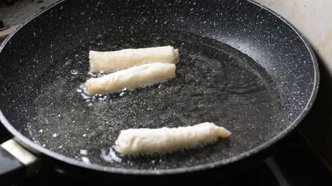 Spring rolls in deep oil Stock Footage 144495857