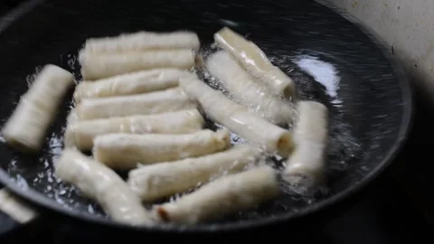 Spring rolls in deep oil Stock Footage 144498060