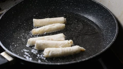 Spring rolls in deep oil Stock Footage 144498665