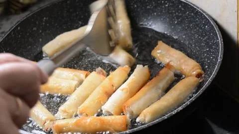 Spring rolls in deep oil Stock Footage 144499165