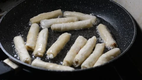 Spring rolls in deep oil Stock Footage 144499480