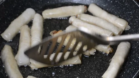 Spring rolls in deep oil Stock Footage 144502477