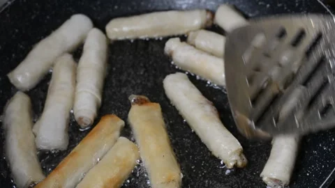 Spring rolls in deep oil Stock Footage 144502551