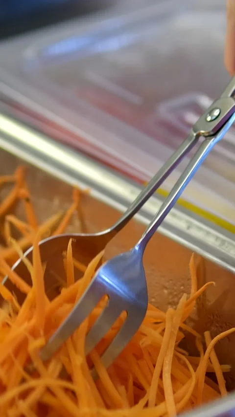 Spring rolls with red fish pile of freshly grated carrot on a wooden cutting Stock Footage 313759402