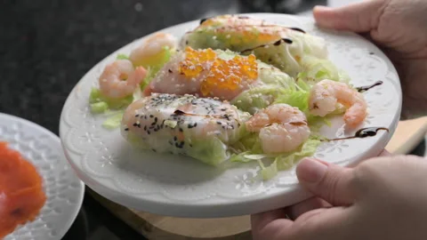 Spring rolls in rice paper. Close-up of a spring roll with beautiful fillings 스톡 동영상 274348394