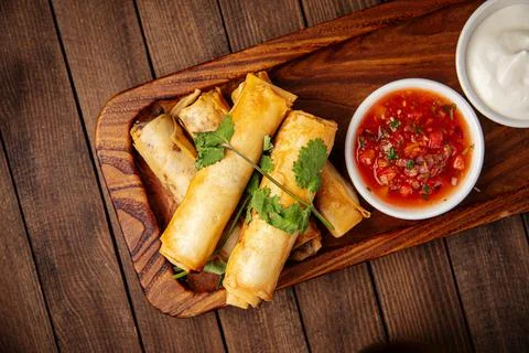 Spring rolls with salsa sauce and sour cream Stock Photos