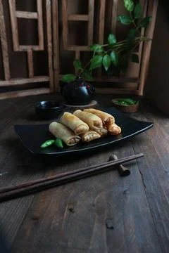 Spring rolls served in a black tray Fotos de archivo