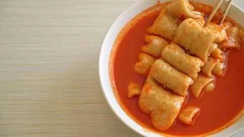 Spring rolls in spicy red sauce on a white bowl Stock Photos