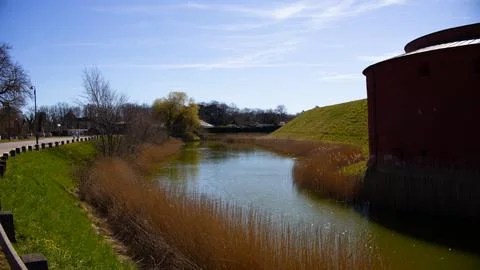 Spring rural landscape with small river, bright blue sky reflect in the water Stock Photos