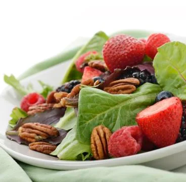 Spring salad with berries and peanuts Stock Photos