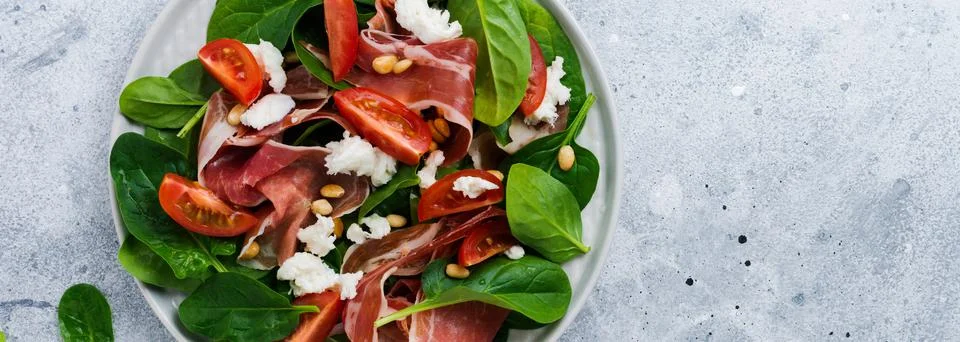 Spring Salad with spinach, cherry tomato, mozzarella, pine nuts and ham with  Stock Photos